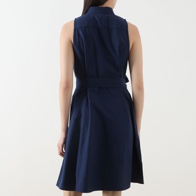 Model wearing Polo Ralph Lauren Polo Player Mini Shirt Dress in navy, back view showing self-tie belt, sleeveless design and A-line skirt.