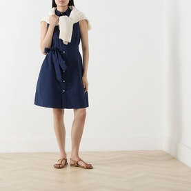 Model wearing Polo Ralph Lauren Polo Player Mini Shirt Dress in navy, sleeveless with button front and self-tie belt, styled with white scarf and tan