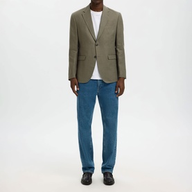 Model wearing Selected Olive Green Suit Jacket, styled with white T-shirt and blue jeans