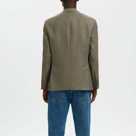 Model wearing Selected olive green suit jacket, rear view, styled with light blue jeans