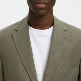 Model wearing Selected olive green suit jacket with notch lapels, styled with a white crew-neck T-shirt underneath