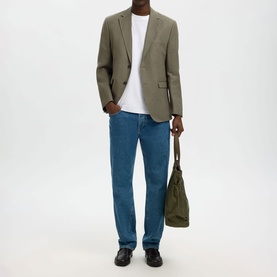 Model wearing Selected Olive Green Suit Jacket with white T-shirt, blue straight-leg jeans and black loafers, carrying olive tote bag.