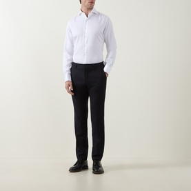 Model wearing Gherardi White Double Cuff Regular shirt in 100% cotton, styled with black tailored trousers and black leather shoes.
