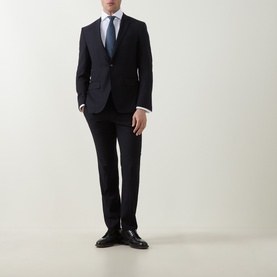Model wearing Gherardi White Double Cuff Regular shirt, styled with navy suit, blue tie and black leather shoes.