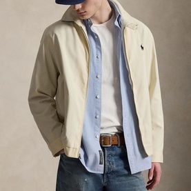 Model wearing Ralph Lauren New Stone casual jacket, styled with light blue shirt, white tee and jeans