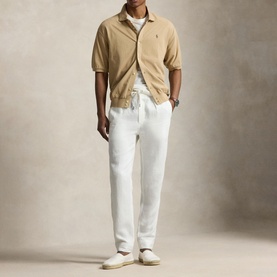 Model wearing Ralph Lauren Vintage Khaki casual shirt with white trousers and white trainers