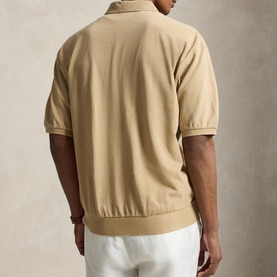 Model wearing Ralph Lauren Vintage Khaki casual shirt, rear view, short sleeves, ribbed hem, styled with white trousers