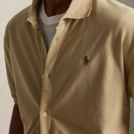 Model wearing Ralph Lauren Casual Shirt in Vintage Khaki, short sleeve with button placket and embroidered Polo Pony logo, styled over grey tee.