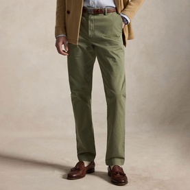 Model wearing Ralph Lauren sage green chinos, styled with a tan blazer, striped shirt, brown belt and tan loafers.