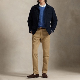 Model wearing Ralph Lauren khaki chino trousers with navy jacket, blue sweater, and brown loafers.