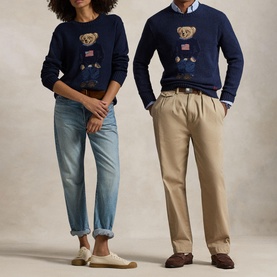 Two models wearing matching navy Polo Ralph Lauren Polo Bear crew neck sweaters, styled with blue jeans and chino trousers