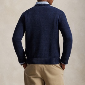 Model wearing navy knit crew-neck jumper, styled with light blue collared shirt and beige chinos, rear view