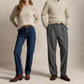 Two models wearing cream cable-knit sweaters; one styled with blue straight-leg jeans and brown boots, other with grey tailored trousers