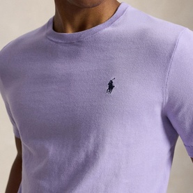 Model wearing Ralph Lauren powder purple crew neck knit with embroidered navy pony logo at chest