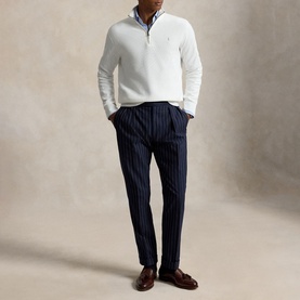 Model wearing Ralph Lauren Deckwash White half-zip knit, styled with navy pinstripe trousers and a blue shirt.
