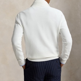 Model wearing Ralph Lauren Deckwash White half zip knit, back view, styled with navy pinstripe trousers.