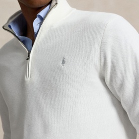 Model wearing Ralph Lauren Deckwash White half-zip knit jumper with polo pony logo, styled with a light blue collar shirt underneath.