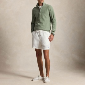 Model wearing Ralph Lauren Fern Green Heather half-zip knit, styled with white drawstring shorts and white canvas trainers.