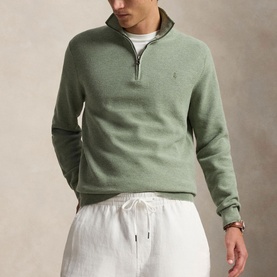 Model wearing Ralph Lauren Fern Green Heather half-zip sweatshirt with quarter zip collar, styled with white drawstring trousers.