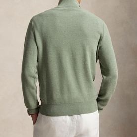 Model wearing Ralph Lauren fern green heather knit half-zip jumper, styled with white trousers. Rear view.