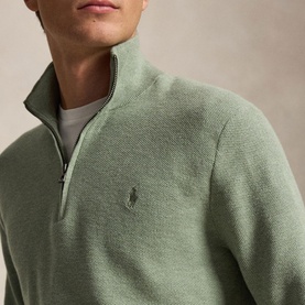 Model wearing Ralph Lauren half-zip knit in Fern Green Heather, with tonal embroidered pony logo, styled over a white crew-neck tee.