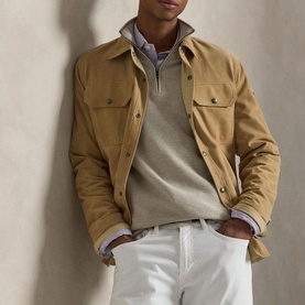 Model wearing Ralph Lauren Light Walnutbrown Hthr half-zip knit, styled with a camel shirt jacket and white trousers.