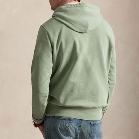 Model wearing Ralph Lauren light green hoodie, rear view, styled with blue jeans.