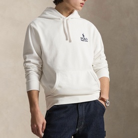 Model wearing Ralph Lauren white hoodie with chest logo, styled with navy jeans and a watch