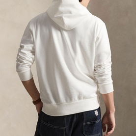 Model wearing Ralph Lauren white hoodie, rear view, styled with dark blue jeans
