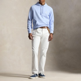 Model wearing Ralph Lauren pebble blue hoodie, styled with white jeans, brown belt and navy canvas trainers