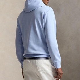 Model wearing Ralph Lauren pebble blue hoodie, back view, styled with white striped-waistband trousers