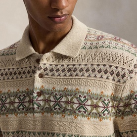 Model wearing a cream Fair Isle knit polo with multicolour geometric and floral patterns, close-up showing textured stitch detail and collar