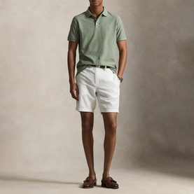 Model wearing Ralph Lauren Greenery Heather polo shirt, styled with white chino shorts and brown leather sandals.