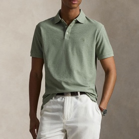 Model wearing Ralph Lauren polo in Greenery Heather, styled with white chinos and a brown belt.