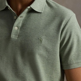 Model wearing Ralph Lauren polo shirt in Greenery Heather, close-up showing tonal embroidered pony logo and three-button placket