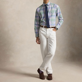 Model wearing Ralph Lauren Reg Shirt in faded mint lavender multi check, styled with white trousers, navy tie and brown loafers