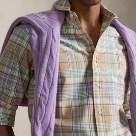 Model wearing Ralph Lauren Reg Shirt in khaki faded mint plaid check, styled with a purple cable-knit sweater draped over shoulders.