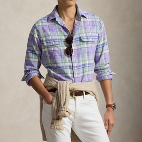 Model wearing Ralph Lauren Reg Shirt in lavender and green multi-check, styled with white trousers, tan belt and knotted cream sweater.