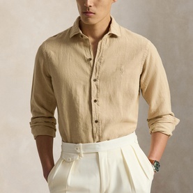 Model wearing Ralph Lauren Coastal Beige linen regular fit shirt with embroidered logo, styled with white wide-leg trousers