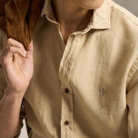 Model wearing Ralph Lauren Coastal Beige linen regular fit shirt with small embroidered logo, styled with a brown suede jacket.