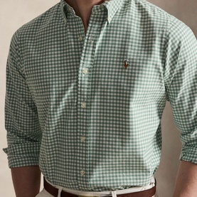 Model wearing Polo Ralph Lauren green gingham check Oxford shirt with button-down collar, styled with a white belt
