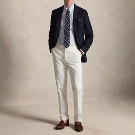 Model wearing Ralph Lauren Cabana Blue White reg shirt, styled with navy blazer, striped tie, and white trousers