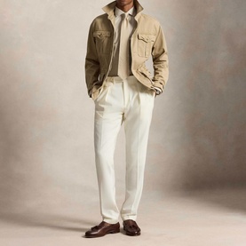 Model wearing Ralph Lauren Performance Twill Logo Shirt in Expedition Dune Heather, styled with tan jacket and white trousers, brown loafers.