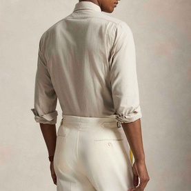 Model wearing Ralph Lauren Performance Twill Logo Shirt in Expedition Dune Heather, rear view, styled with cream tailored trousers