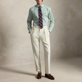Model wearing Ralph Lauren Faded Mint regular fit shirt with cream pleated trousers, striped tie and brown loafers