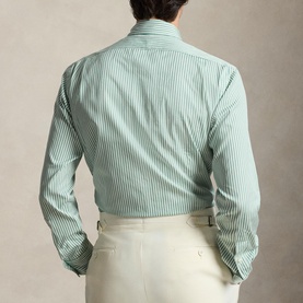 Model wearing Ralph Lauren Reg Shirt in faded mint and white stripe, styled with cream trousers, rear view