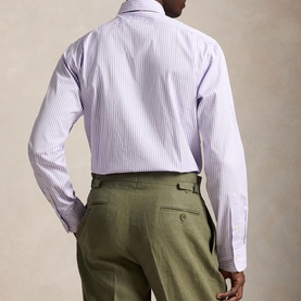 Model wearing Ralph Lauren Reg Shirt in powder purple and white stripe, shown from behind, styled with olive green trousers.