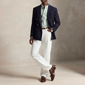 Model wearing Ralph Lauren Pony Logo Striped Poplin Shirt in Faded Mint, styled with navy double-breasted blazer, white trousers and brown loafers