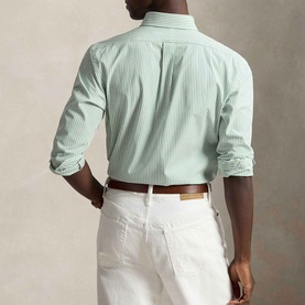 Model wearing Ralph Lauren Pony Logo Striped Poplin Shirt in Faded Mint/White, rear view, styled with white trousers and brown belt.