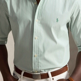 Model wearing Ralph Lauren Pony Logo Striped Poplin Shirt in Faded Mint/White, styled with white trousers and brown leather belt.